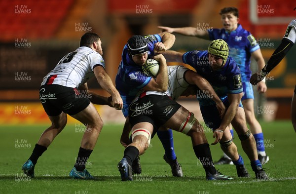 081224 - Ospreys v Emirates Lions, EPCR Challenge Cup - Morgan Morris of Ospreys is tackled by WJ Steenkamp of Lions 