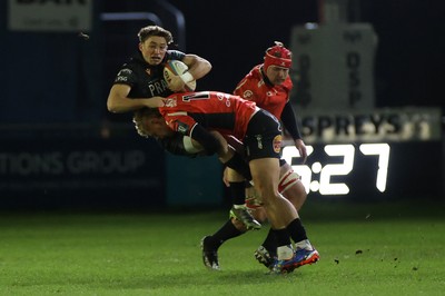 230126 - Ospreys v Emirates Lions - United Rugby Championship - Dan Edwards of Ospreys is tackled by Richard Kriel of Lions 