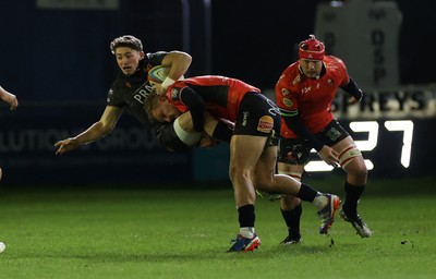 230126 - Ospreys v Emirates Lions - United Rugby Championship - Dan Edwards of Ospreys is tackled by Richard Kriel of Lions 
