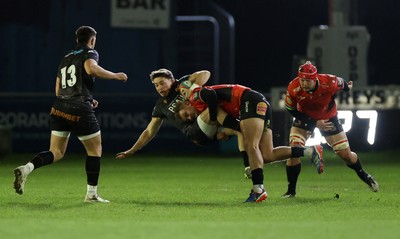 230126 - Ospreys v Emirates Lions - United Rugby Championship - Dan Edwards of Ospreys is tackled by Richard Kriel of Lions 
