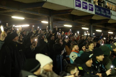 230126 - Ospreys v Emirates Lions - United Rugby Championship - Ospreys fans protest the potential changes to Welsh Rugby during the game on the 11th minute