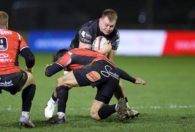 230126 - Ospreys v Emirates Lions - United Rugby Championship - Dewi Lake of Ospreys is tackled by Chris William Smith of Lions 
