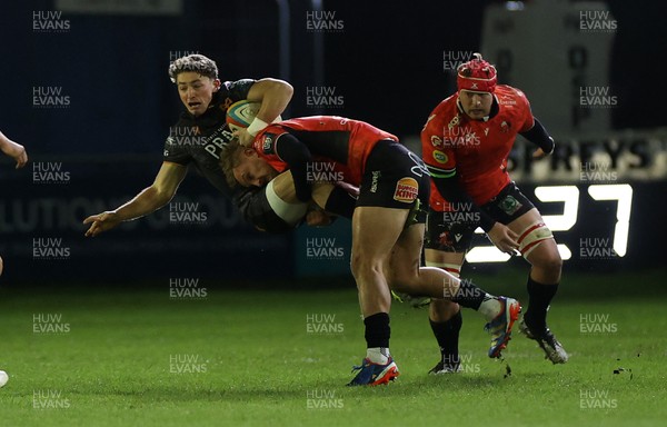 230126 - Ospreys v Emirates Lions - United Rugby Championship - Dan Edwards of Ospreys is tackled by Richard Kriel of Lions 
