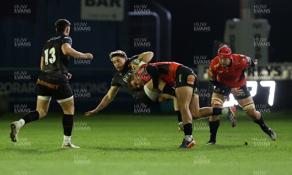 230126 - Ospreys v Emirates Lions - United Rugby Championship - Dan Edwards of Ospreys is tackled by Richard Kriel of Lions 