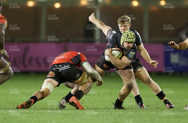 230126 - Ospreys v Emirates Lions - United Rugby Championship - Harri Deaves  of Ospreys is tackled by Francke Horn of Lions 