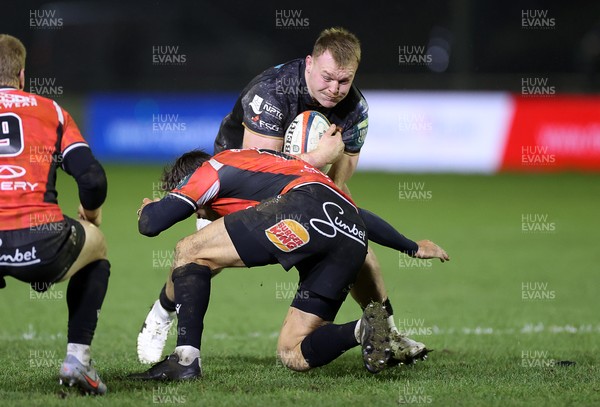 230126 - Ospreys v Emirates Lions - United Rugby Championship - Dewi Lake of Ospreys is tackled by Chris William Smith of Lions 