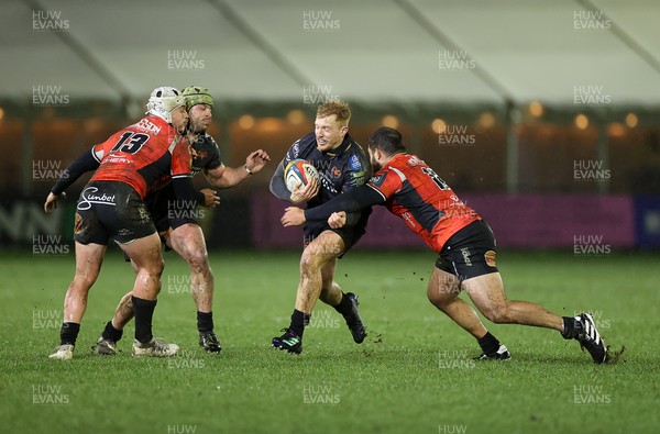 230126 - Ospreys v Emirates Lions - United Rugby Championship - Iestyn Hopkins of Ospreys is tackled by Henco van Wyk of Lions 