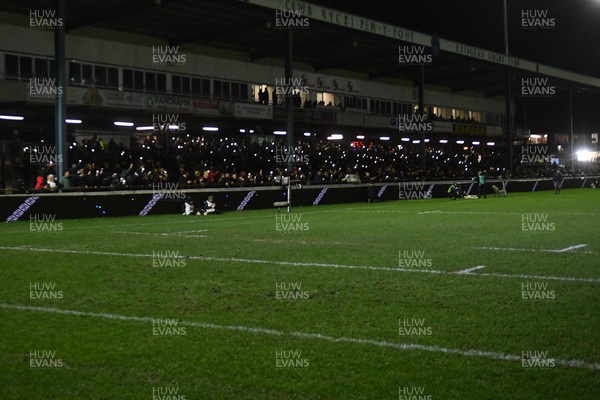 230126 - Ospreys v Emirates Lions - United Rugby Championship - Ospreys fans shine their phone lights in protest in the 11th minute