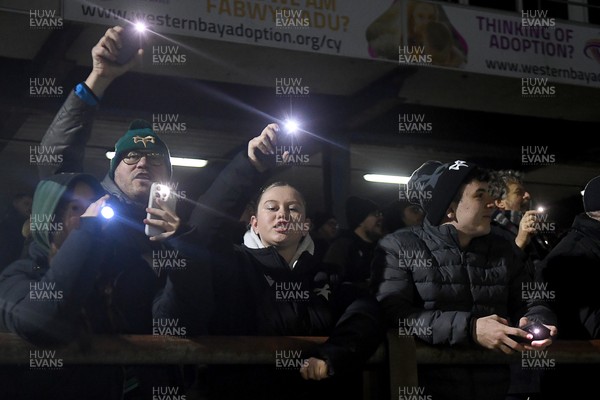 230126 - Ospreys v Emirates Lions - United Rugby Championship - Ospreys fans shine their phone lights in protest in the 11th minute