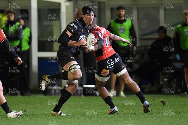 230126 - Ospreys v Emirates Lions - United Rugby Championship - Ryan Smith of Ospreys is challenged by Angelo Davids of Lions