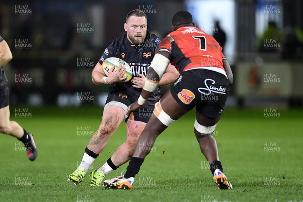 230126 - Ospreys v Emirates Lions - United Rugby Championship - Steffan Thomas of Ospreys is challenged by Batho Hlekani of Lions