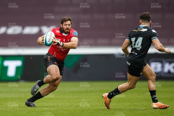 300324 - Ospreys v Emirates Lions - United Rugby Championship - Marius Louw of Lions takes on Luke Morgan of Ospreys