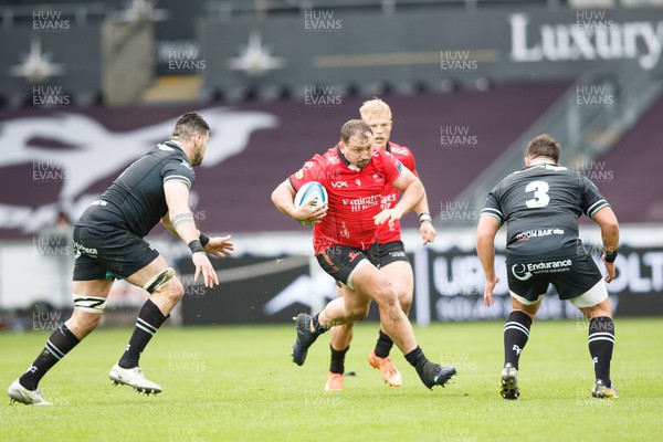 300324 - Ospreys v Emirates Lions - United Rugby Championship - JP Smith of Lions takes on Rhys Davies and Tom Botha of Ospreys