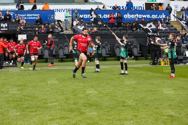 300324 - Ospreys v Emirates Lions - United Rugby Championship - Marius Louw of Lions leads his team onto the pitch