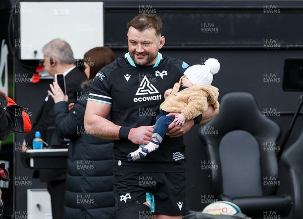 300324 - Ospreys v Emirates Lions - United Rugby Championship - Sam Parry of Ospreys with his child before the match, on the occasion of his 150th appearance
