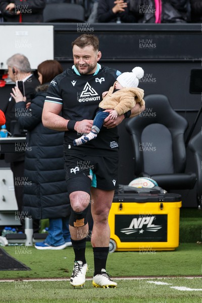 300324 - Ospreys v Emirates Lions - United Rugby Championship - Sam Parry of Ospreys with his child before the match, on the occasion of his 150th appearance