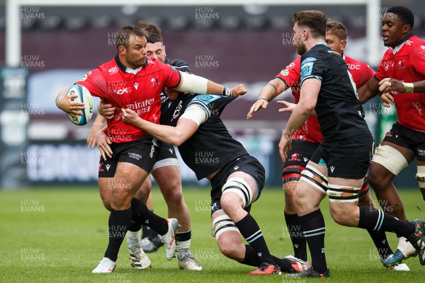 300324 - Ospreys v Emirates Lions - United Rugby Championship - Conrad van Vuuren of Lions is tackled by Adam Beard of Ospreys
