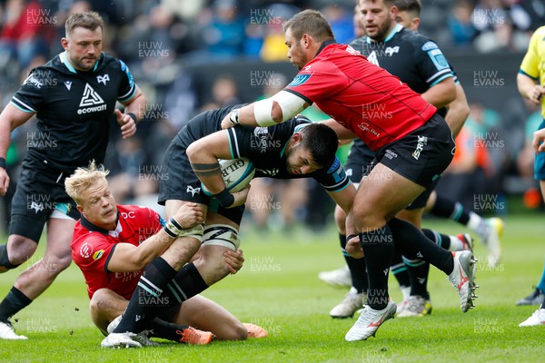 300324 - Ospreys v Emirates Lions - United Rugby Championship - Rhys Davies of Ospreys tackled by JC Pretorius of Emirates Lions