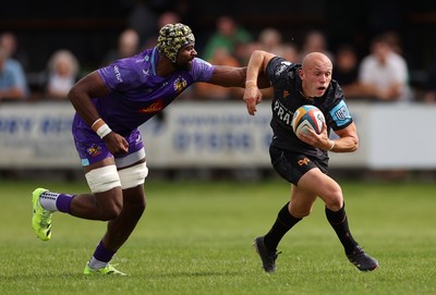 060925 - Ospreys v Exeter Chiefs - Pre Season Friendly - Luke Davies of Ospreys is challenged by Christ Tshiunza of Exeter 