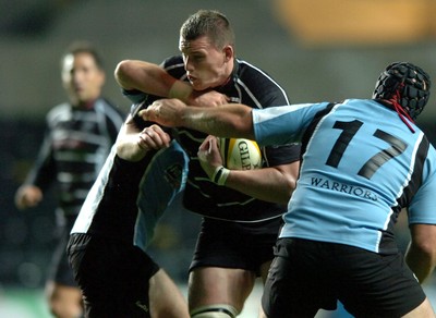 13.10.06  Ospreys v Gasgow  Ospreys  Ian Evans is tackled by John Barclay and Kevin Tkachuk.   