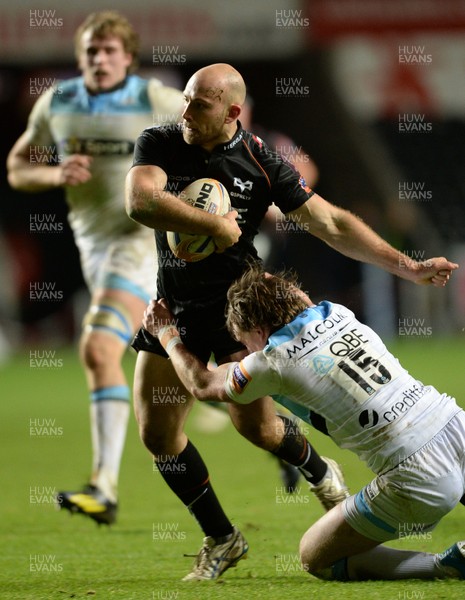 291113 - Ospreys v Glasgow - RaboDirect PRO12 -Richard Fussell of Ospreys is tackled by Stuart Hogg of Glasgow