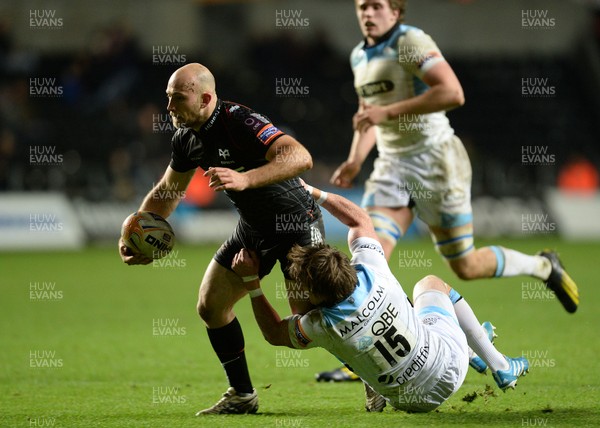 291113 - Ospreys v Glasgow - RaboDirect PRO12 -Richard Fussell of Ospreys is tackled by Stuart Hogg of Glasgow