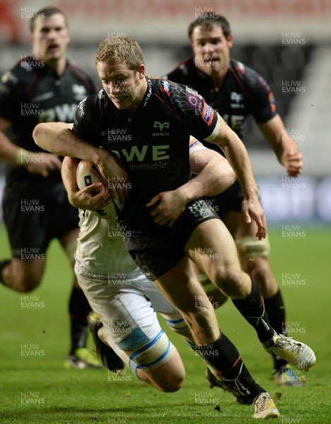 291113 - Ospreys v Glasgow - RaboDirect PRO12 -Tom Isaacs of Ospreys is tackled by Jonny Gray of Glasgow