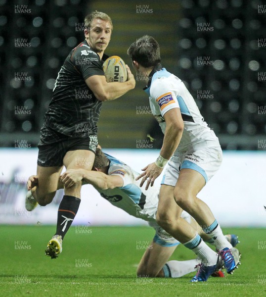 291113 - Ospreys v Glasgow Warriors - RaboDirect PRO12 - Tom Isaacs of Ospreys is taken down by Sean Lamont and DTH Van Der Merwe of Glasgow 