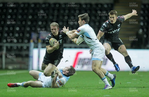 291113 - Ospreys v Glasgow Warriors - RaboDirect PRO12 - Tom Isaacs of Ospreys is taken down by Sean Lamont and DTH Van Der Merwe of Glasgow 