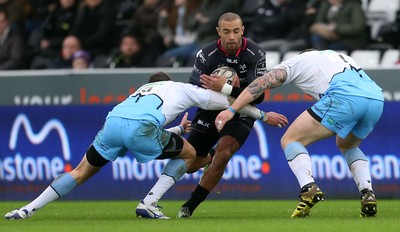 310116 - Ospreys v Glasgow - Guinness PRO12 - Eli Walker of Ospreys is tackled by Lee Jones and Gordon Reid of Glasgow