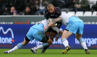 310116 - Ospreys v Glasgow - Guinness PRO12 - Eli Walker of Ospreys is tackled by Lee Jones and Gordon Reid of Glasgow