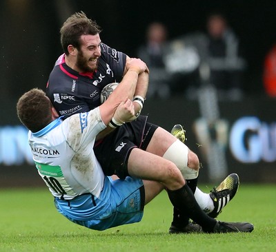 310116 - Ospreys v Glasgow - Guinness PRO12 - Tom Grabham of Ospreys is tackled by Duncan Weir of Glasgow