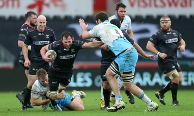 310116 - Ospreys v Glasgow - Guinness PRO12 - Joe Bearman of Ospreys is tackled by Pat MacArthur and Greg Peterson of Glasgow