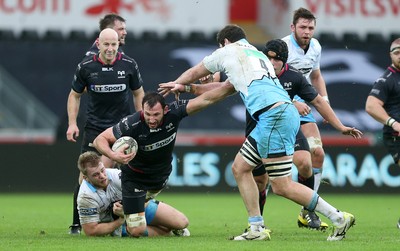 310116 - Ospreys v Glasgow - Guinness PRO12 - Joe Bearman of Ospreys is tackled by Pat MacArthur and Greg Peterson of Glasgow