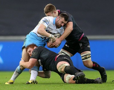 310116 - Ospreys v Glasgow - Guinness PRO12 - Rory Hughes of Glasgow is tackled by Dan Baker and Olly Cracknell of Ospreys