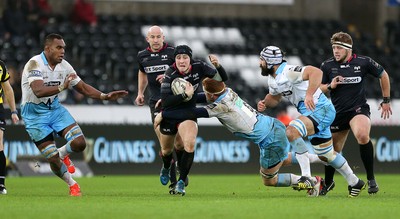 310116 - Ospreys v Glasgow - Guinness PRO12 - Sam Davies of Ospreys is tackled by Rob Harley and Josh Strauss of Glasgow