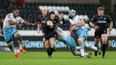 310116 - Ospreys v Glasgow - Guinness PRO12 - Sam Davies of Ospreys is tackled by Rob Harley and Josh Strauss of Glasgow