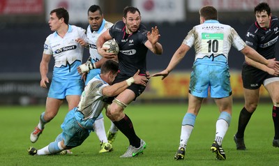 310116 - Ospreys v Glasgow - Guinness PRO12 - Joe Bearman of Ospreys is tackled by Grayson Hart of Glasgow