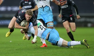 310116 - Ospreys v Glasgow - Guinness PRO12 - Ben John of Ospreys is tackled by Glenn Bryce of Glasgow