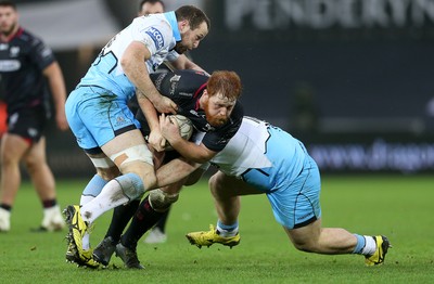 310116 - Ospreys v Glasgow - Guinness PRO12 - Dan Baker of Ospreys is tackled by James Eddie and D'arcy Rae of Glasgow