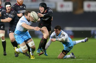 310116 - Ospreys v Glasgow - Guinness PRO12 - Sam Davies of Ospreys is tackled by James Eddie and Peter Murchie of Glasgow