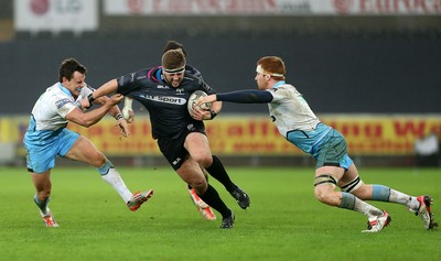 310116 - Ospreys v Glasgow - Guinness PRO12 - Scott Otten of Ospreys is tackled by Lee Jones and Rob Harley of Glasgow