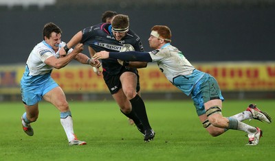 310116 - Ospreys v Glasgow - Guinness PRO12 - Scott Otten of Ospreys is tackled by Lee Jones and Rob Harley of Glasgow