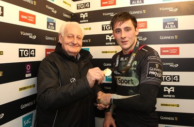 310116 - Ospreys v Glasgow Warriors - GuinnessPro12 -Sam Davies of Ospreys receives the man of the match award from Feeney King of Guinness