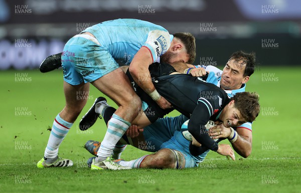 111123 - Ospreys v Glasgow Warriors - United Rugby Championship - Jack Walsh of Ospreys is tackled by Ollie Smith and Henco Venter of Glasgow 