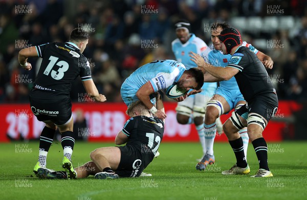 111123 - Ospreys v Glasgow Warriors - United Rugby Championship - Ollie Smith of Glasgow is tackled by Keiran Williams of Ospreys 