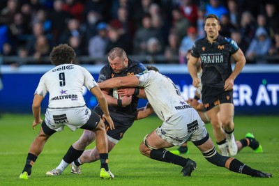 180426 - Ospreys v Hollywoodbets Sharks - United Rugby Championship - Sam Parry of Ospreys is tackled by Emile van Heerden of Hollywoodbets Sharks