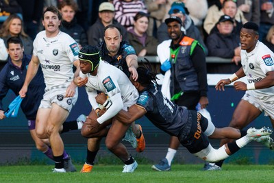 180426 - Ospreys v Hollywoodbets Sharks - United Rugby Championship - Zekhethelo Siyaya of Sharks is tackled by Dan Kasende of Ospreys