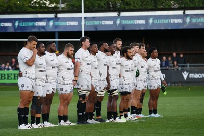 180426 - Ospreys v Hollywoodbets Sharks - United Rugby Championship - The Sharks team observe a minute's silence in memory of Christopher ‘Chippie’ Solomon, the Stormers team manager