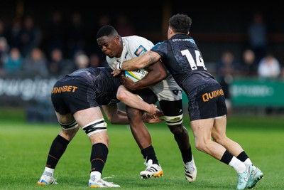 180426 - Ospreys v Hollywoodbets Sharks - United Rugby Championship - Manu Tshituka of Sharks is tackled by James Ratti and Luke Morgan of Ospreys